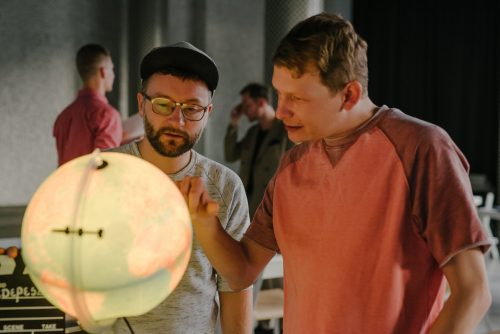 Zdjęcie, twórcy cyklu oglądają świecący się globus